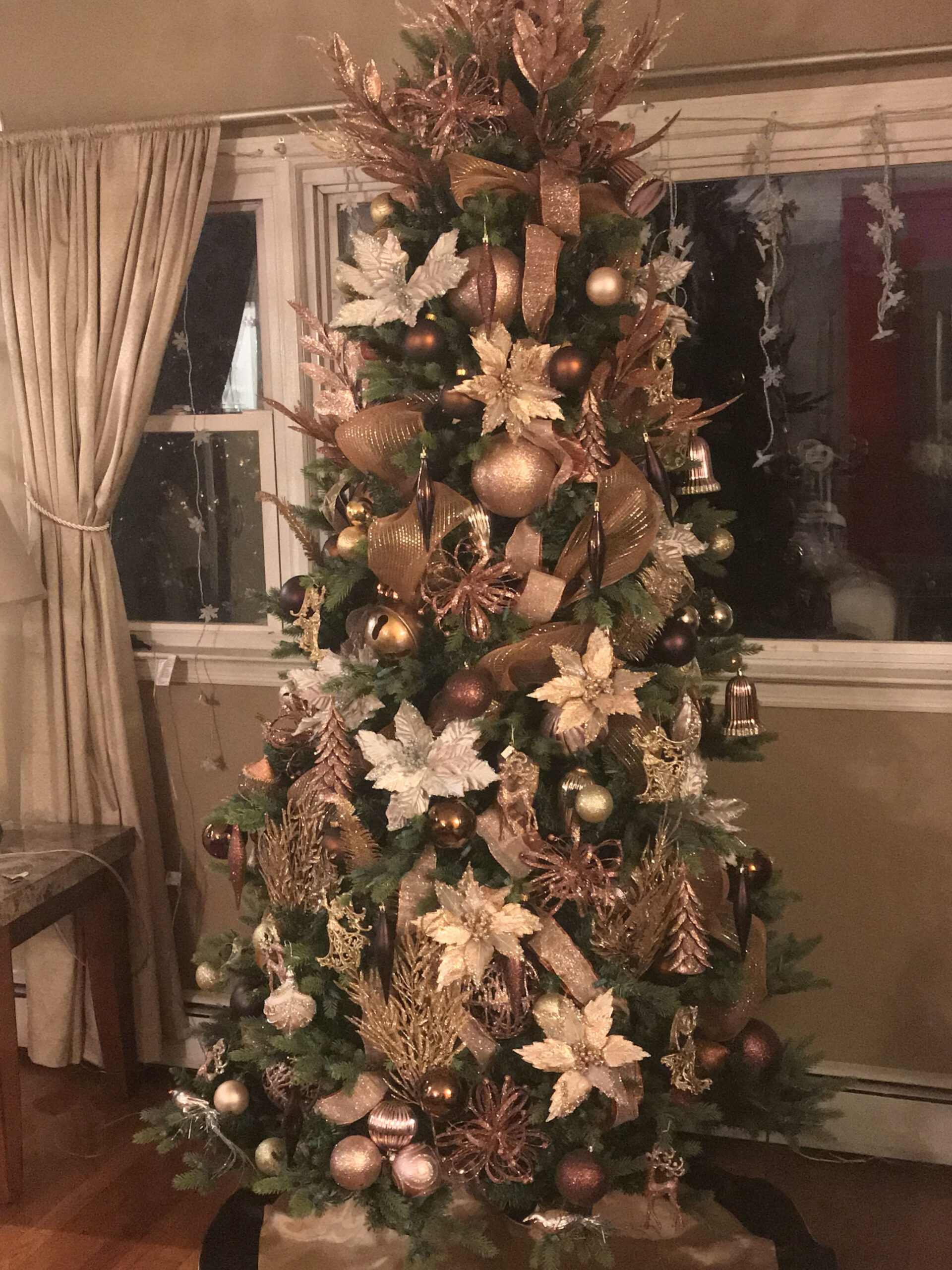 Green tree with brown, copper and gold ornaments