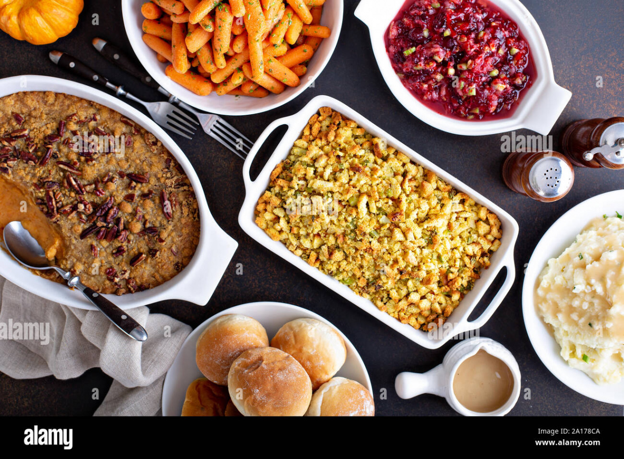 Variety of Thanksgiving sides on the dinner table, carrots, mashed