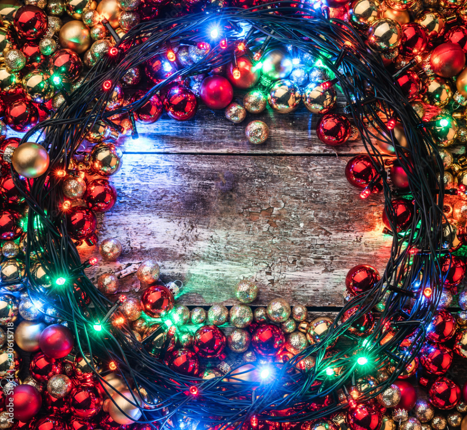 Christmas background with red and gold baubles, lighted around, in