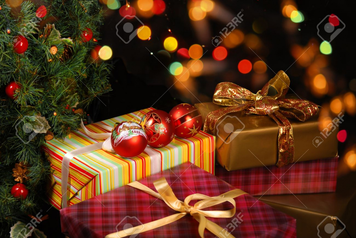 Gifts Under The Christmas Tree Lights Background Stock Photo