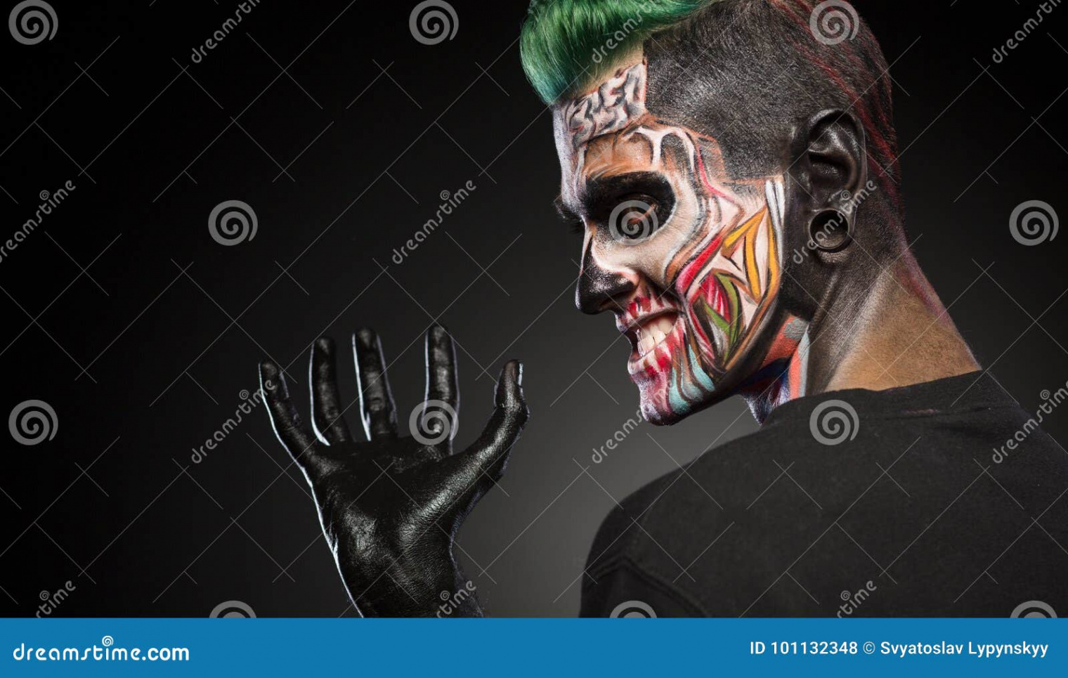 Side View of a Man with Monster Face Make Up and Hand Painted in