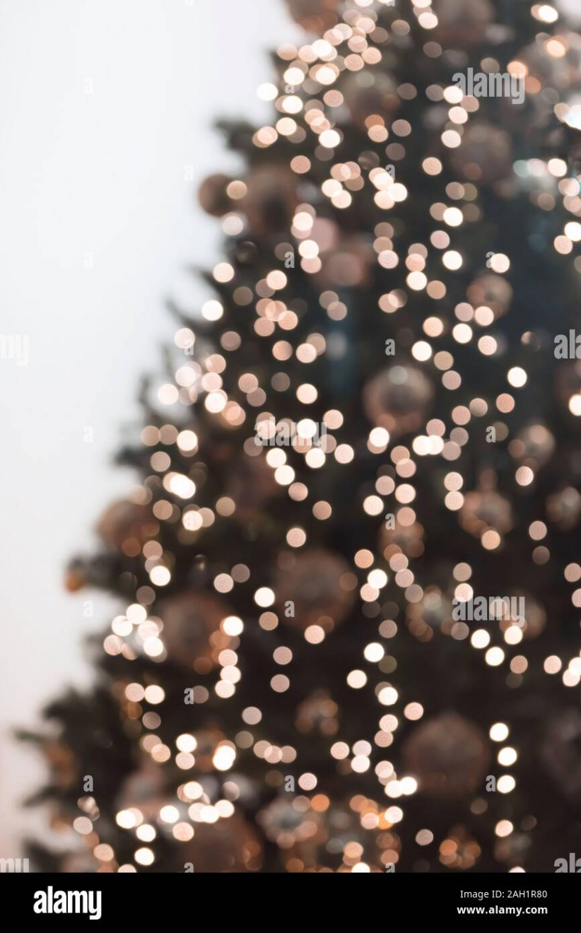 Vertical view of blurred christmas tree with garlands